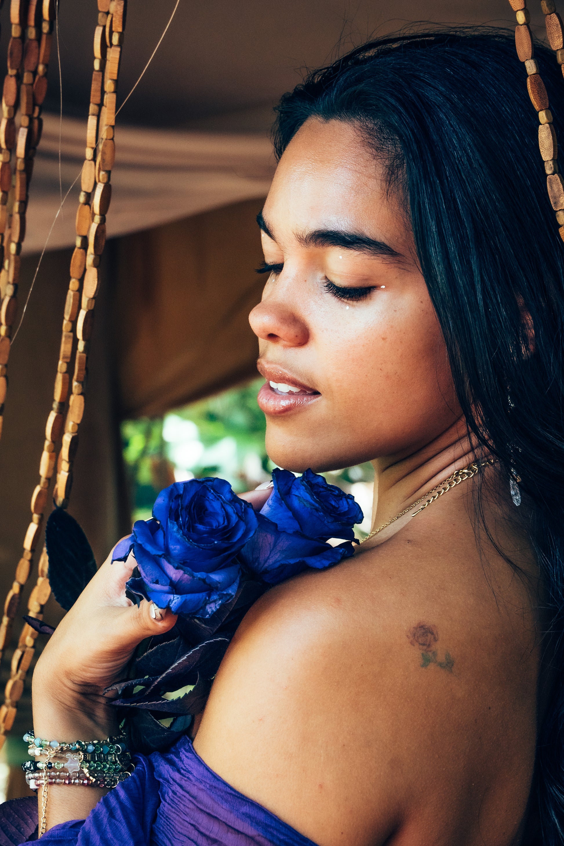Woman holding blue flowers with a blurred background