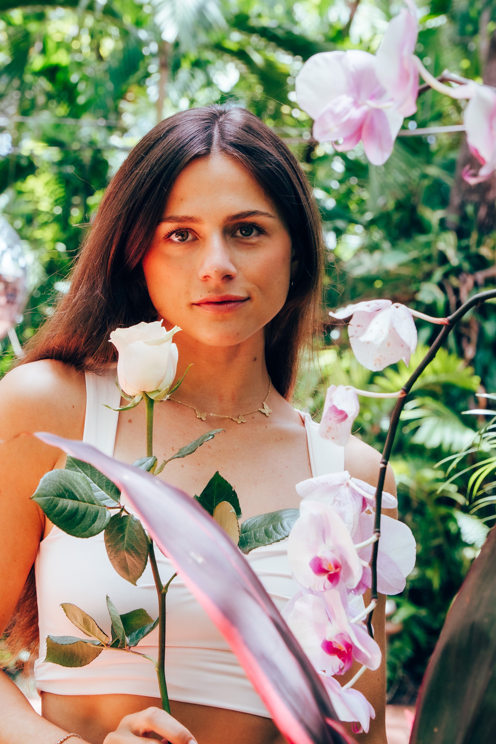 Woman holding pink roses in a garden setting