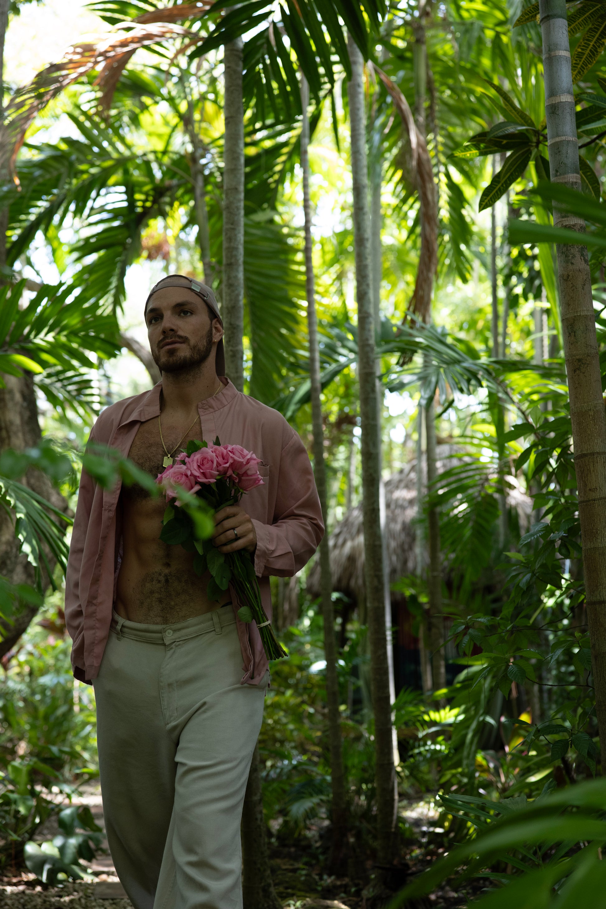 Man holding flowers in a forest