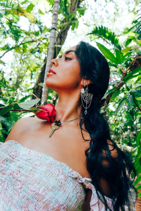 Woman with a hot pink rose in a tropical setting