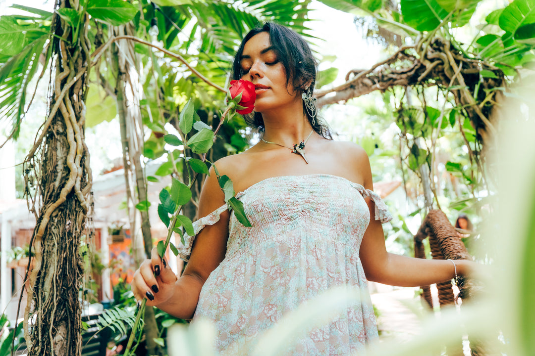 Woman holding a hot pink in a tropical setting
